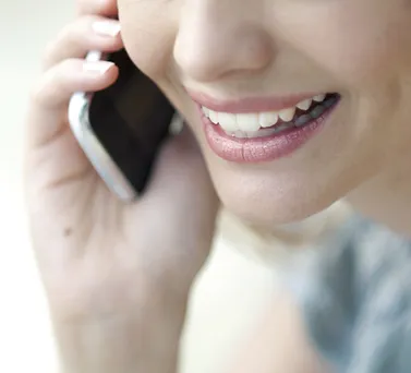 A smiling woman on the phone